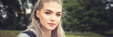 blonde girl with blue eyes and dark eyebrows