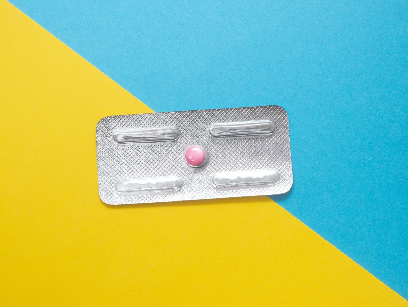 one pill on a blue and yellow split background