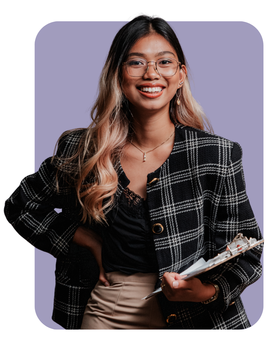 woman wearing glasses smiling and holding a clipboard