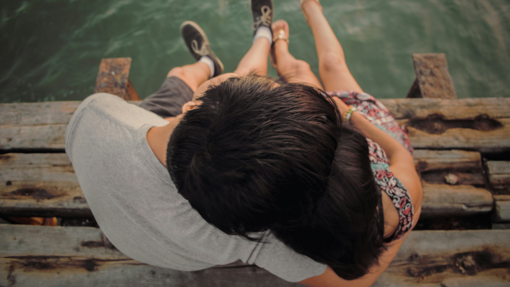 couple sitting on a dock